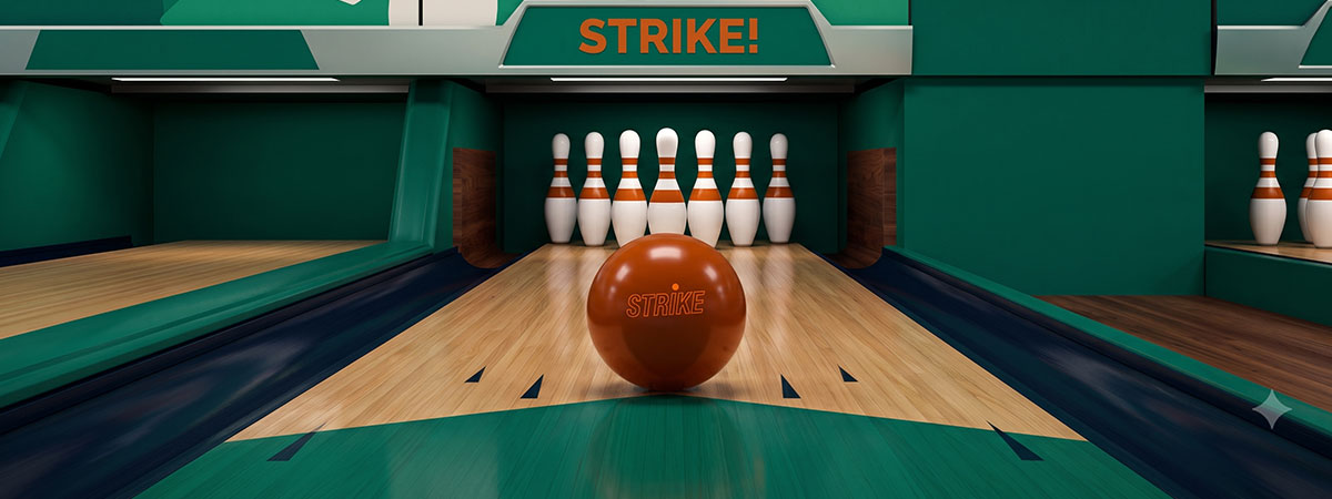 An orange bowling ball with the word "STRIKE" sits on a wooden lane facing seven pins in a green-themed bowling alley.